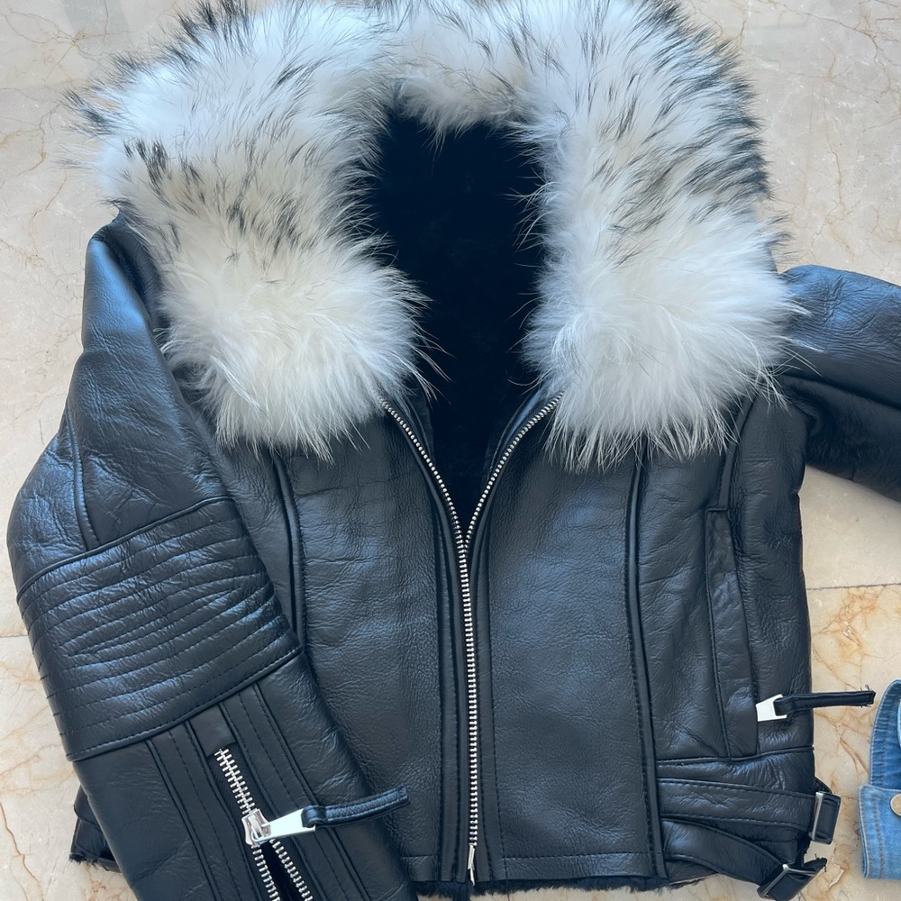 Black leather moto jacket with white fur collar